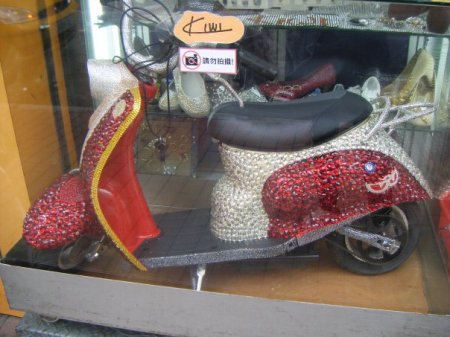 Completely and totally bedazzled scooter. Obviously someone needs a new hobby.