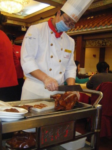 The chef slicing up our official Peking duck, tableside.