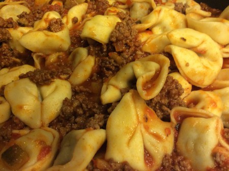 sausage tortelloni pasta with meat sauce dish