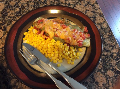 plated beef and spinach enchiladas